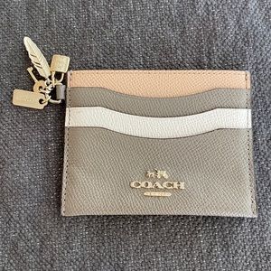 Coach credit card holder with charms.